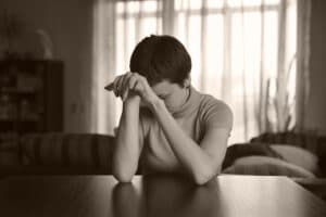 Woman sitting with hands folded