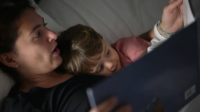 Mom reading a book at bedtime