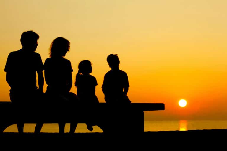 Family of four at sunset