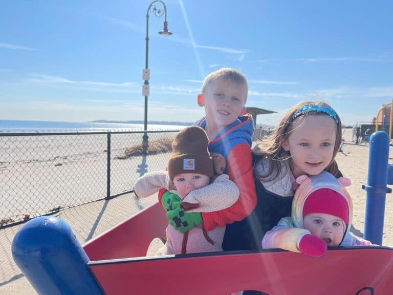 Four kids on the beach, color photo