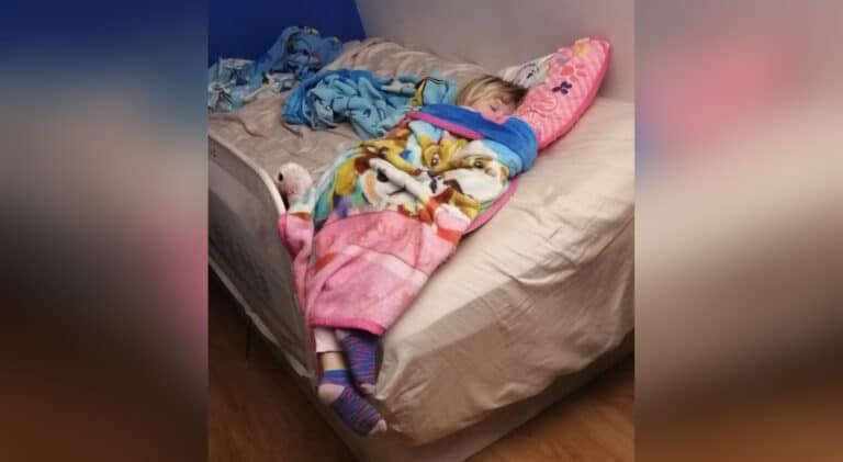 little girl sleeping in bed