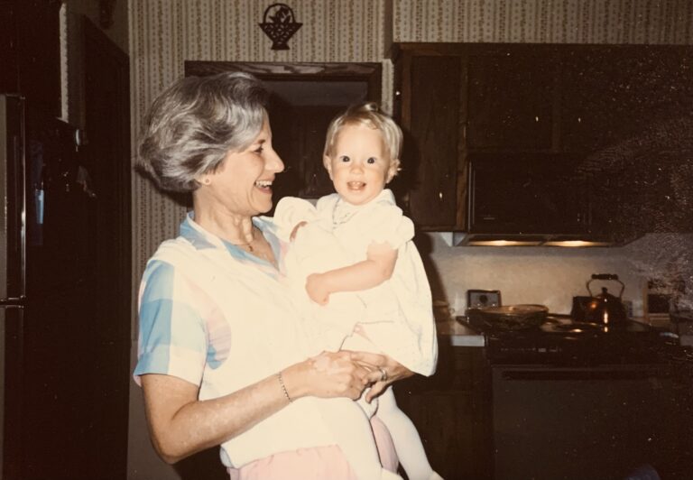 Grandmother holding baby, color photo