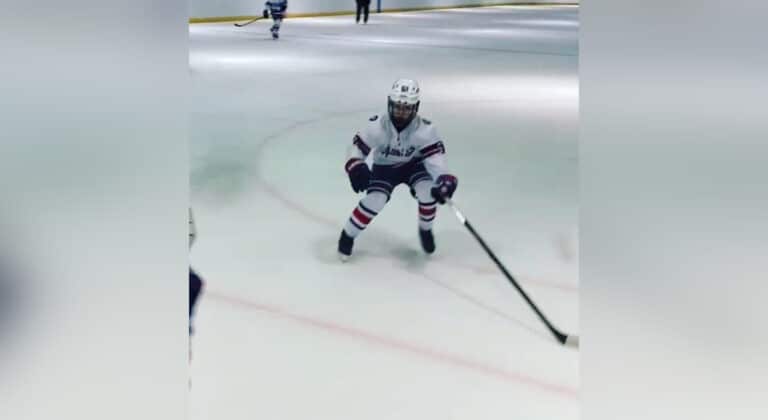 Tween boy playing hockey, color photo