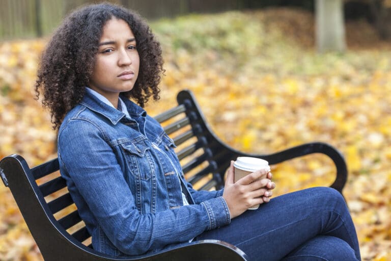 Woman sitting on bench alone