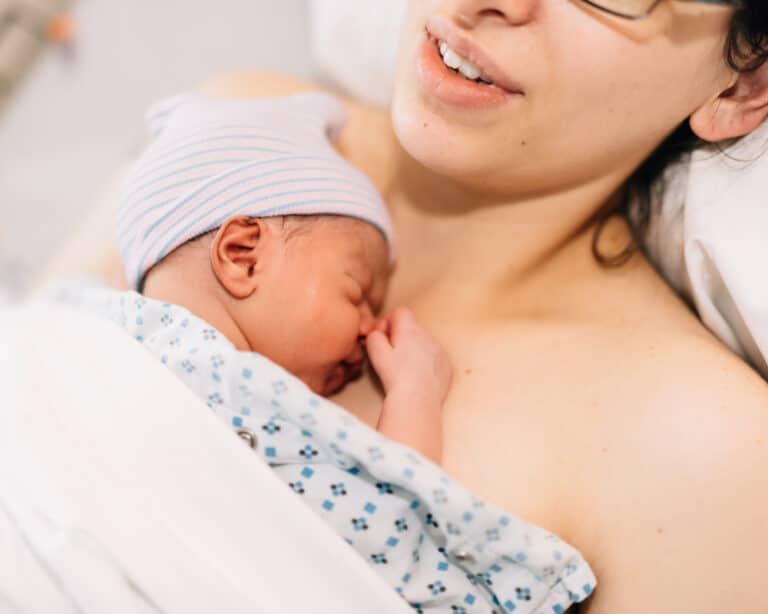 newborn baby on mother's chest