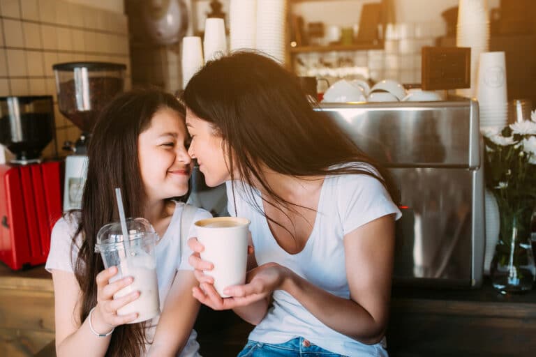Mother and daughter drink coffee