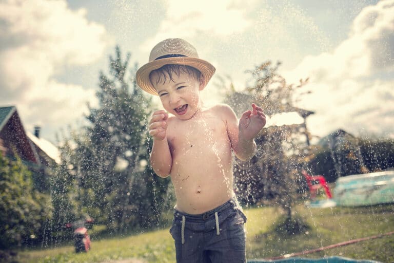Little boy in sprinkler