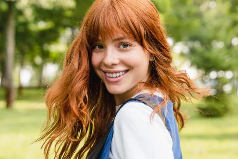 Teen with red hair smiling