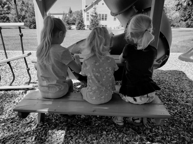 Sisters sitting on park bench