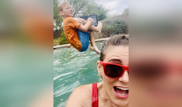 Child jumping in pool behind mother