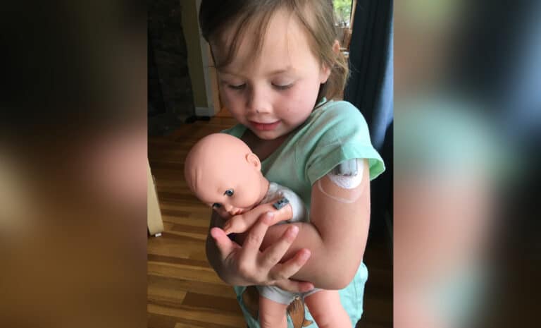 Child holding baby doll