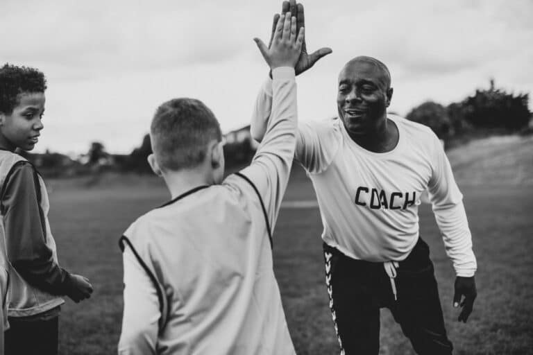 Coach giving high five to child