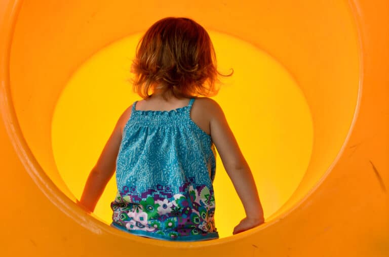 Little girl in tunnel slide