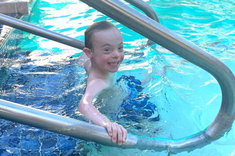 Little boy with Down syndrome in pool