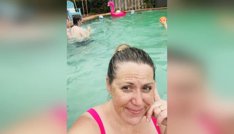Mother in pool with teens in background