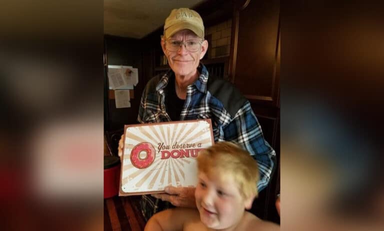 grandpa holding donut box with grandson