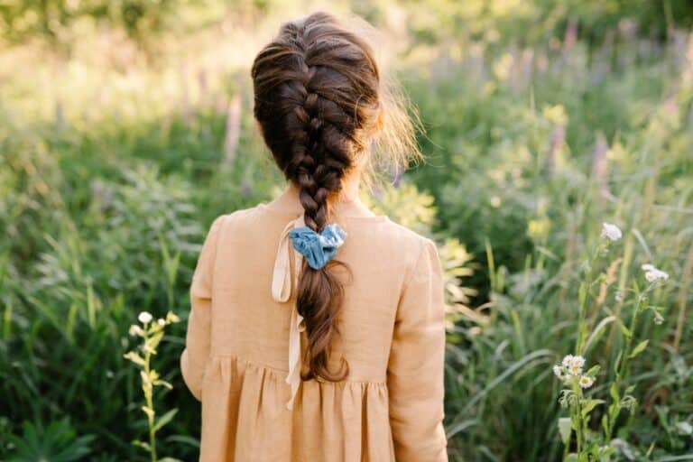 Back of little girl's head with braid and ribbon