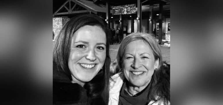 Two women smiling, black-and-white photo