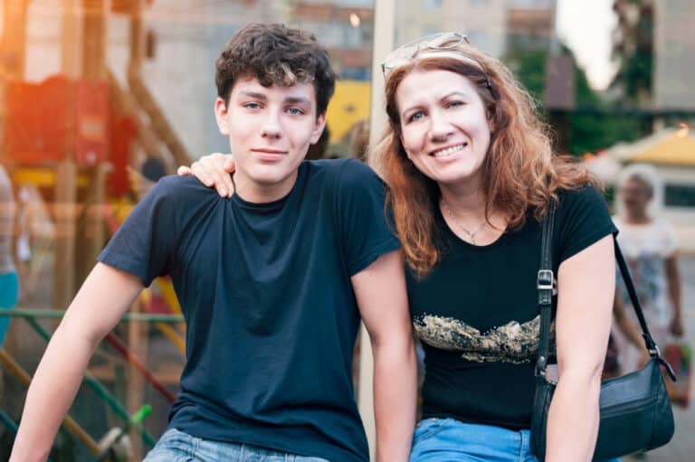 Mom and teen son smiling