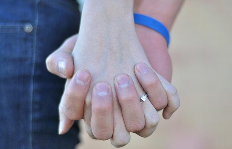 Husband and wife holding hands, color photo