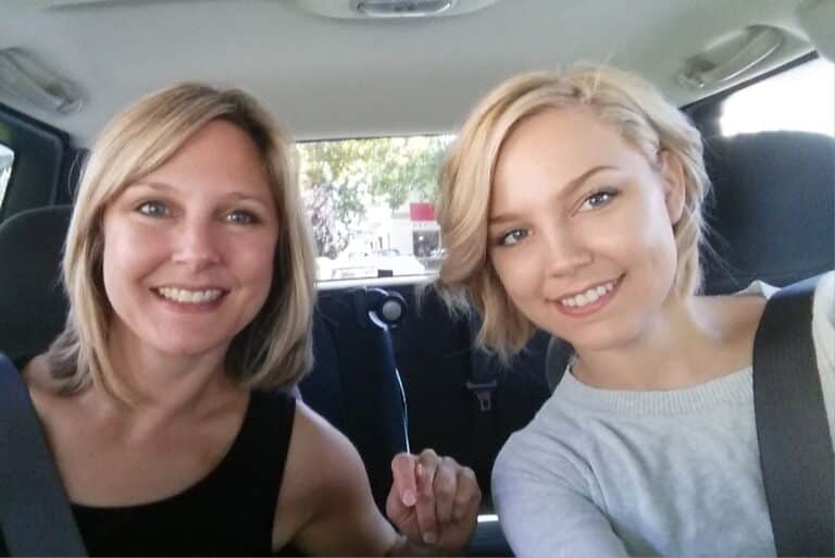 Mother and grown daughter smiling in selfie