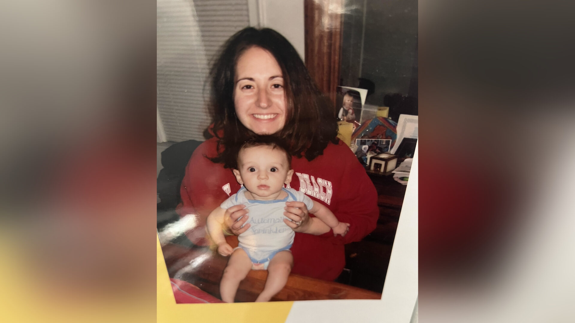 Woman holding baby, color photo