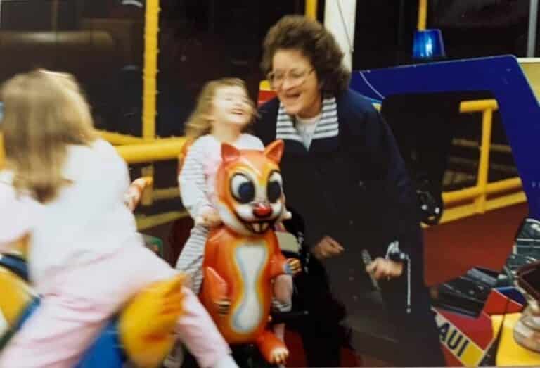 Old photo of grandmother and young granddaughter laughing