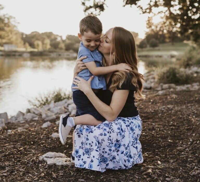 Mother hugging young son, color photo
