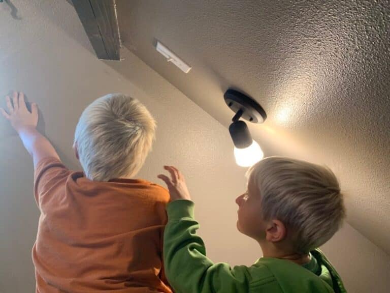 Two kids looking at the ceiling, color photo