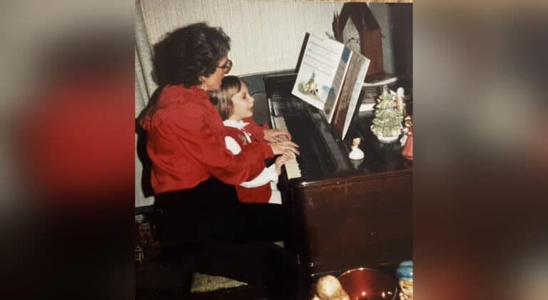 Little girl and grandma playing piano