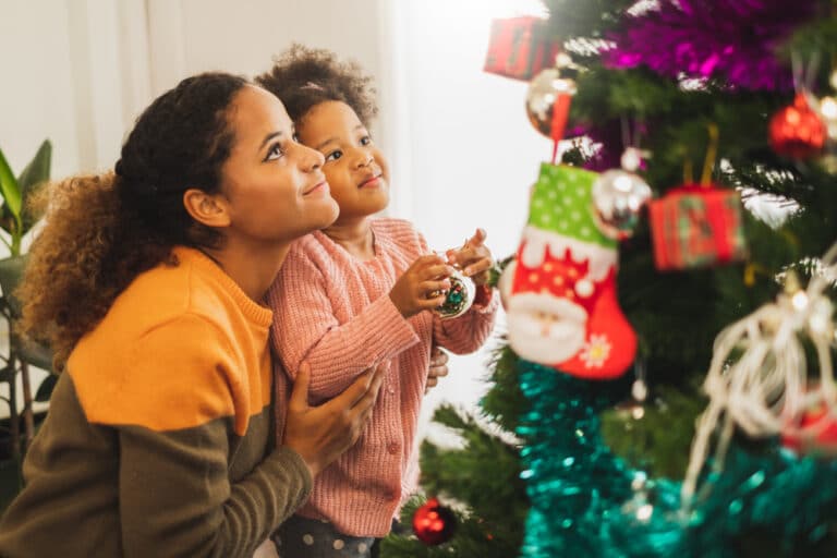 Mom and little girl looking at Christmas tree