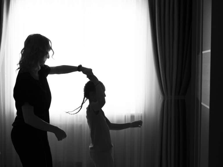 Mom twirling little girl silhouette