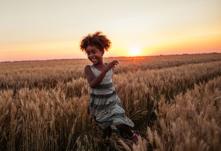 Laughing little girl at sunset