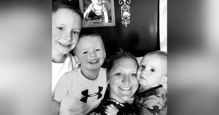 Mother and three boys, black-and-white photo