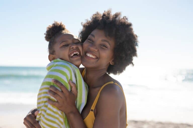 Happy mother and daughter on the beach