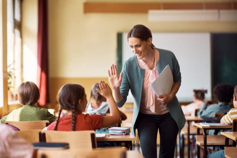 Teacher with student high fiving