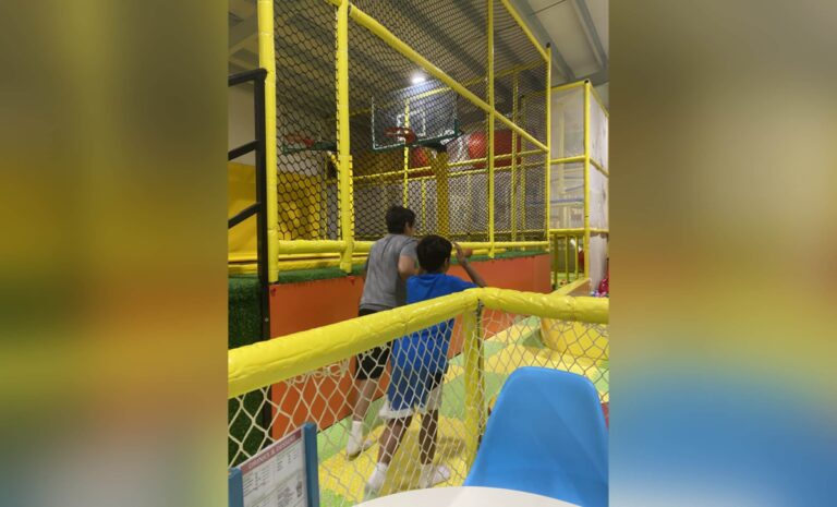 Two boys at indoor playground, color photo
