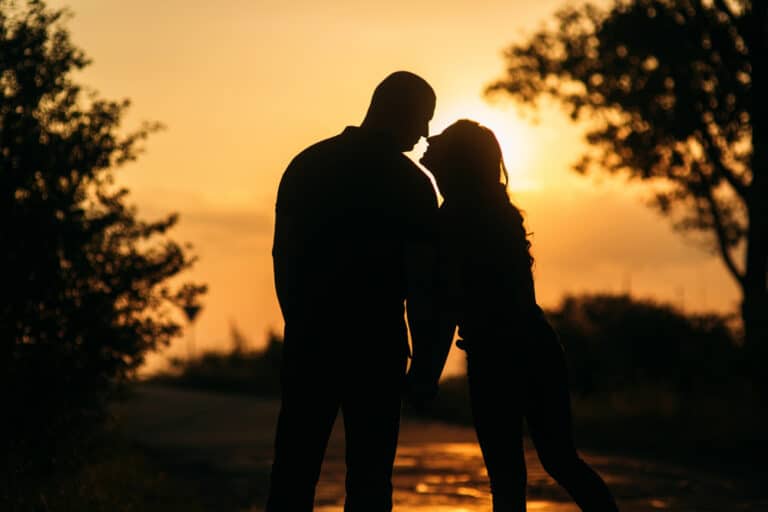Couple looking at each other in sunset silhouette