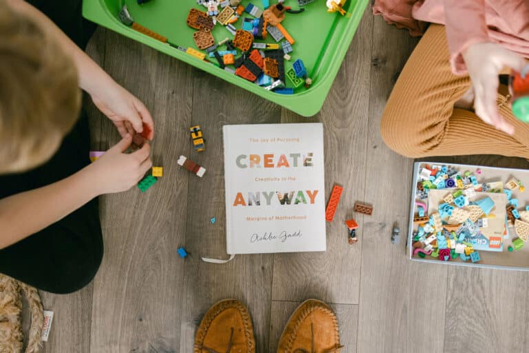 Create Anyway book in the middle of kids playing with building blocks on floor