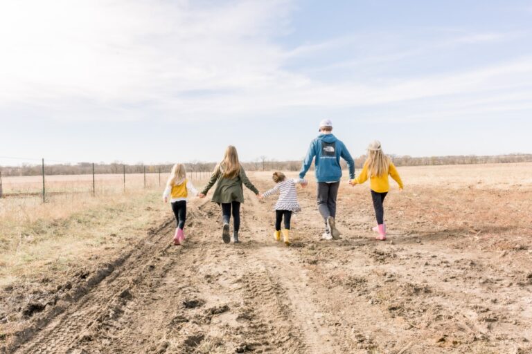 Five children walking hand-in-hand, color photo