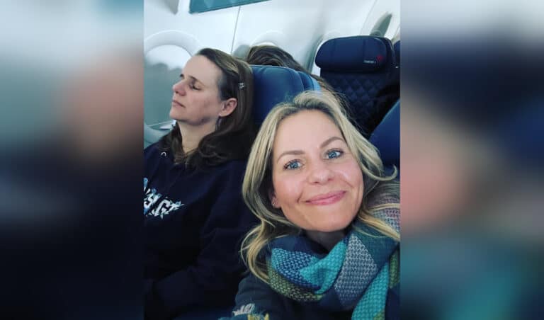 Candace Cameron Bure Andrea Barber on an airplane, taking a selfie with sleeping woman by window