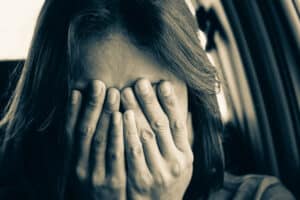 Sad woman hands over face