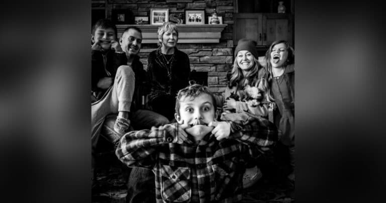 Family photo with kids making silly faces, black-and-white photo