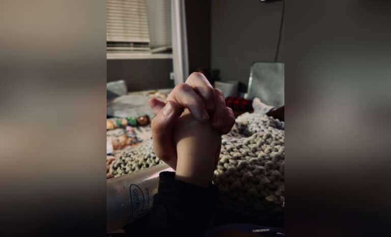 Hands folded in prayer, color photo