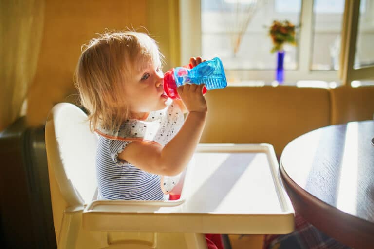 Toddler girl drinking from sippy cup