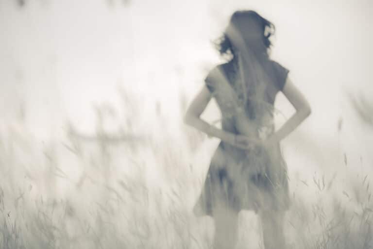Woman standing in distance, blurred photo