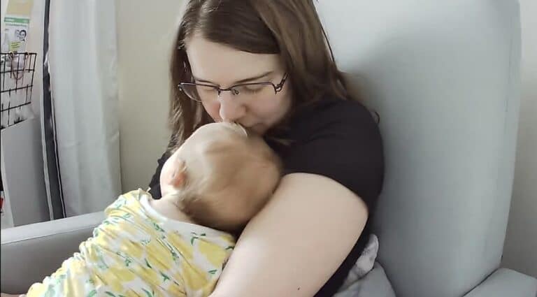 Mother holding baby, color photo