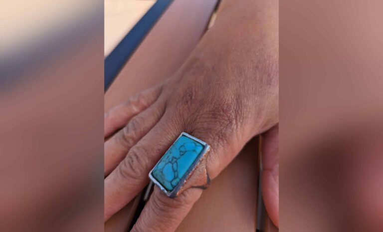 Large ring on woman's hand, color photo