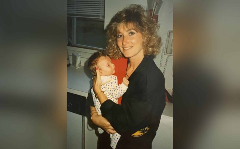 Mother holding infant, older color photo