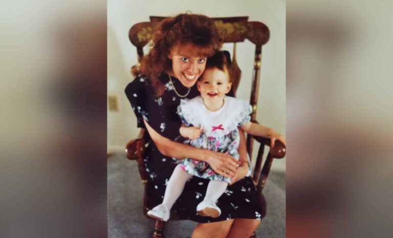 Mother holding daughter in rocking chair, color photo from 90s